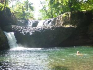swimming in waterfall pool